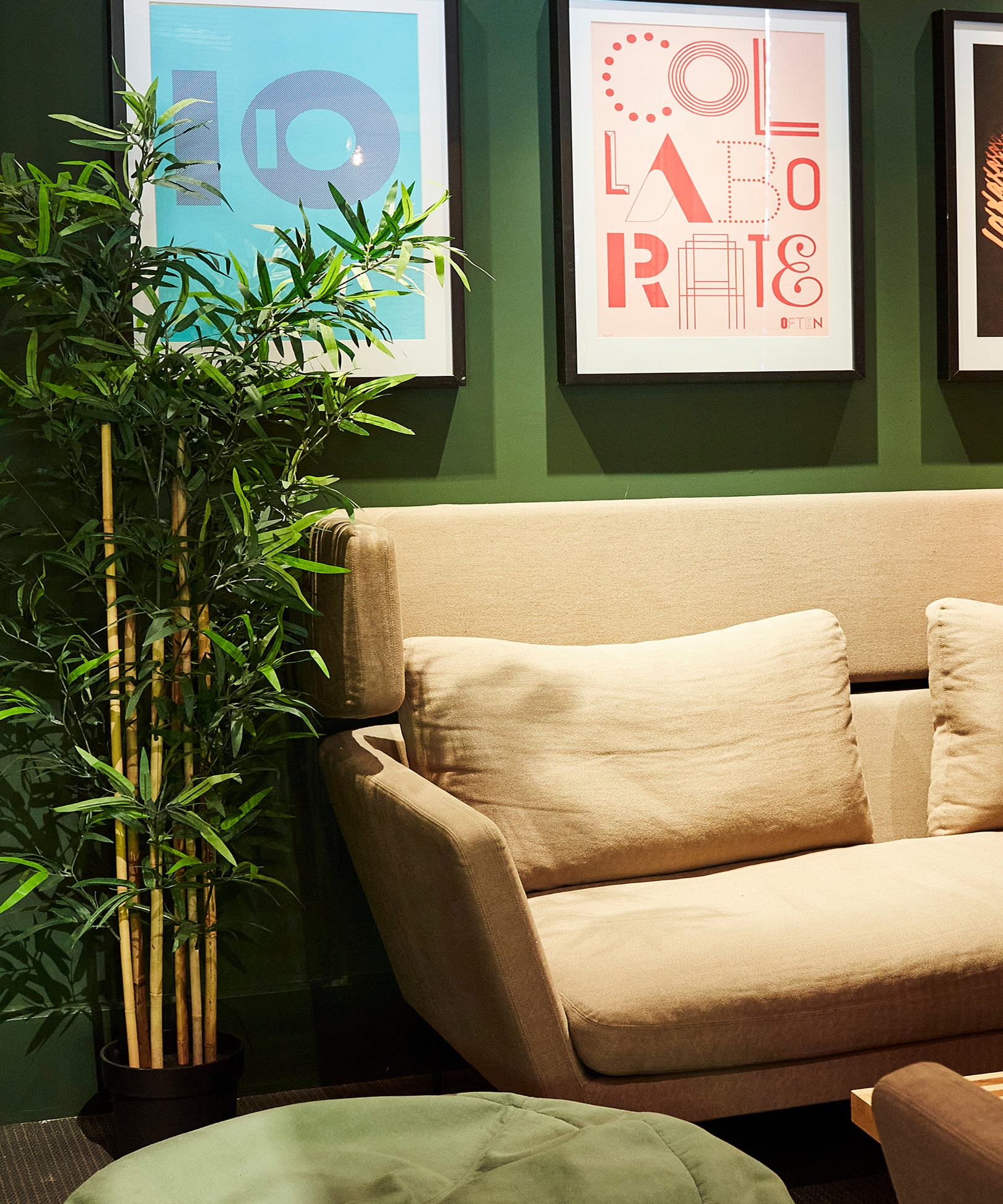 Sofa against a dark green wall